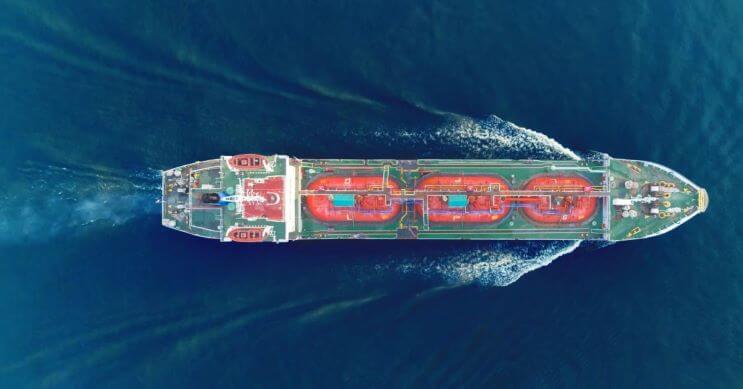 A modern container ship sailing on open waters, exemplifying advanced container load planning and efficient global logistics.