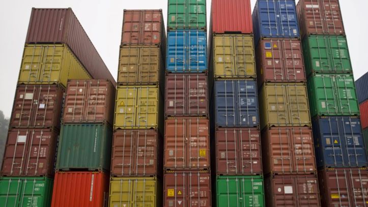 Stacked freight containers at a busy port, showcasing efficient shipping container transport.