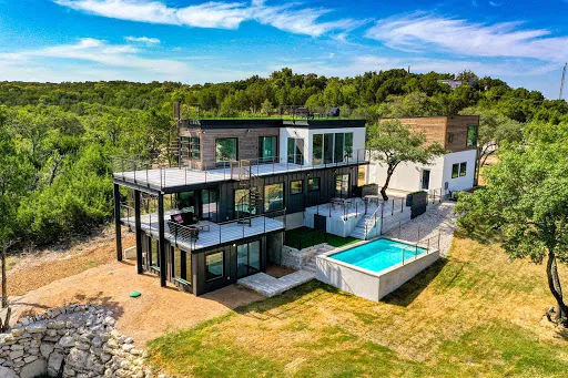 Vila made from shipping containers overviewing Lake Travis in Texas, US; truck and container loading software