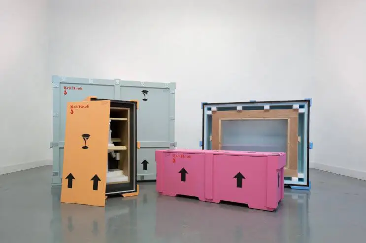Picture showing how one does transport fine art. Metal boxes are used, making sure the packaging is safe for seamless transportation. In this picture, a packaging by Red Hook Crating is shown. For art transportation, they use shipment optimizing software EasyCargo.