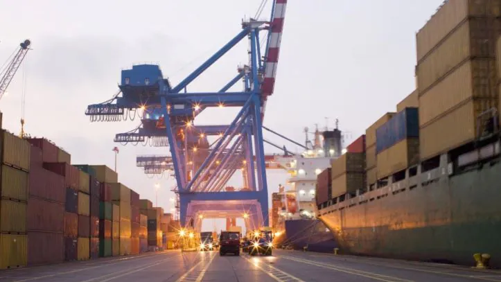 A port road lined with shipping containers, highlighting the infrastructure needed for shipping containers internationally.