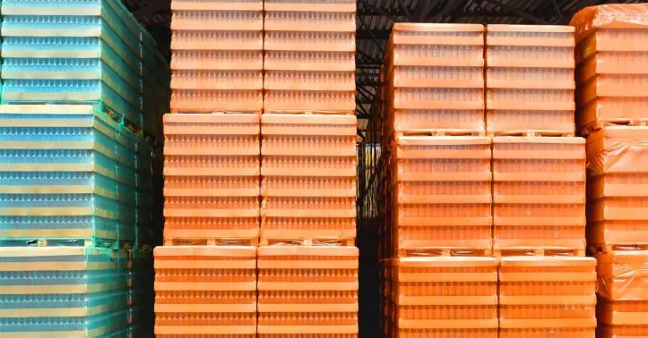 Neatly stacked pallets with secured goods wrapped in plastic, ensuring safe weight distribution and compliance in warehouse logistics